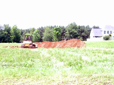 Scrape off the top soil from the lot and stock plie