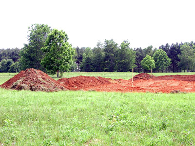Top soil stock piles and cleared house area