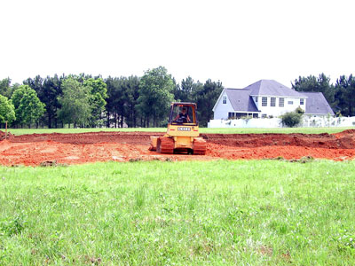 Spreading out the hauled in fill material