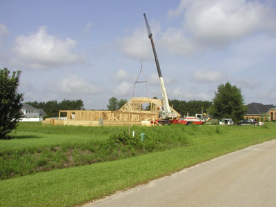 Big expsenisive crane placing trusses..
