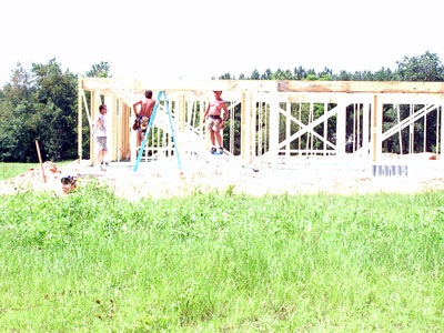 Framers get the front porch beam installed...