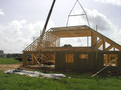 Crane drops in the next truss..