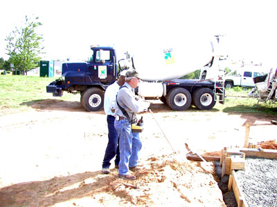 Concrete pumper truck operater with his remote controls to run truck...