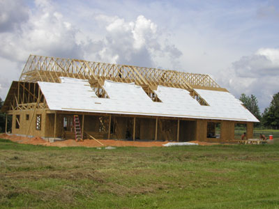 The roof sheathing inches up the trusses...